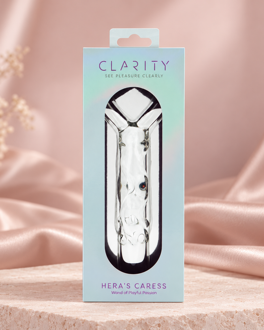 Clarity Hera's Caress glass wand package on a blush-pink premium studio set